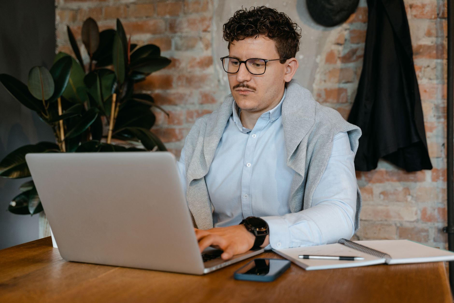 UK startup founder reviewing financial modelling tools on dual monitors in a London office