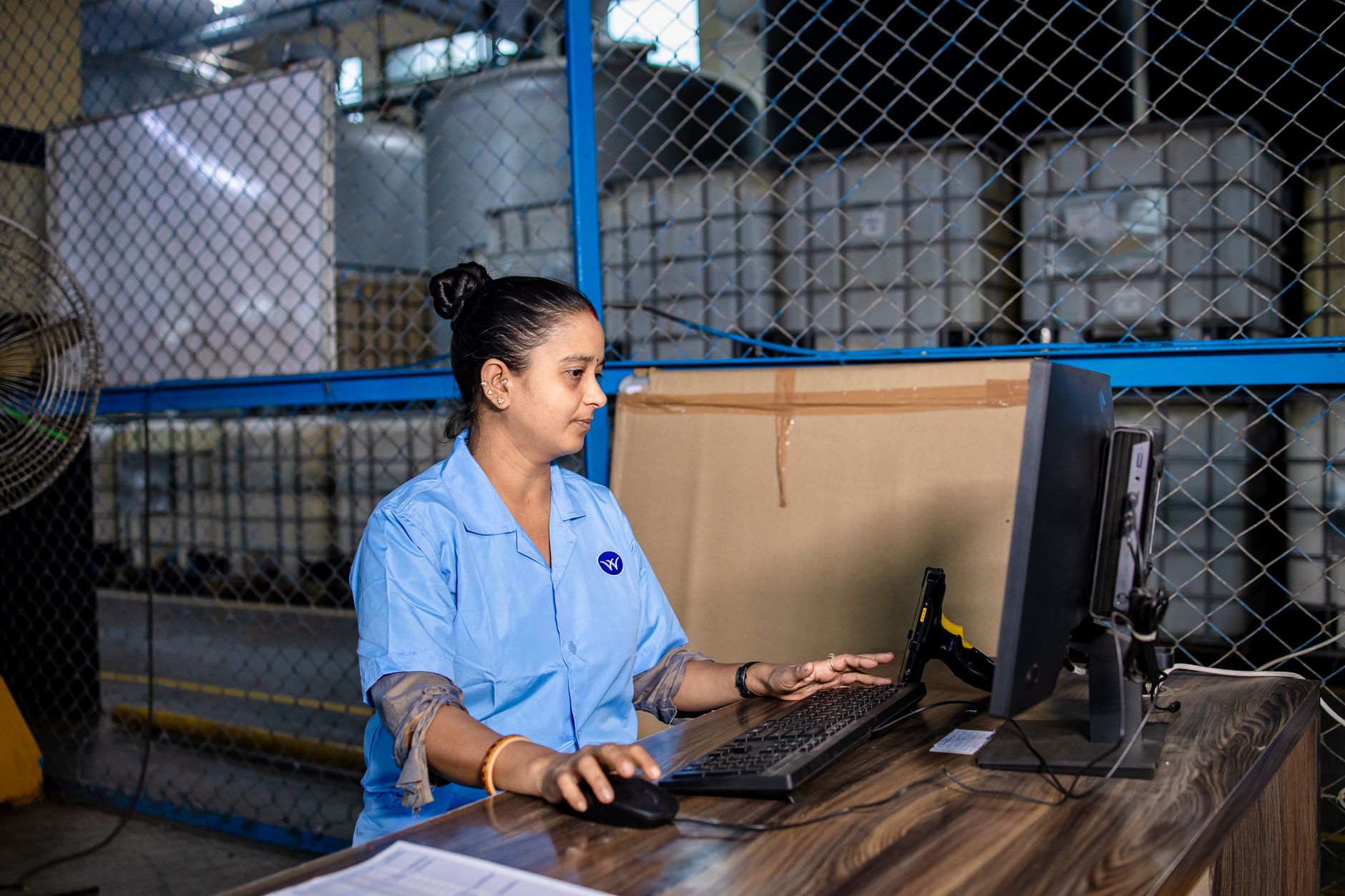 Warehouse operative using warehouse management system as part of UK logistics automation programme
